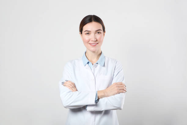 istock Young woman doctor on light background close-up 1355481238