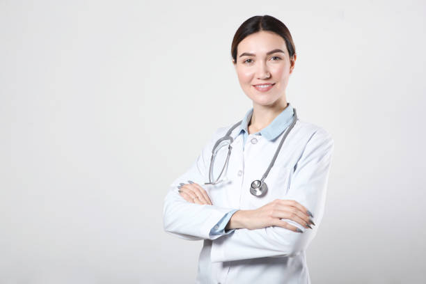 istock Young woman doctor on light background close-up 1355481366