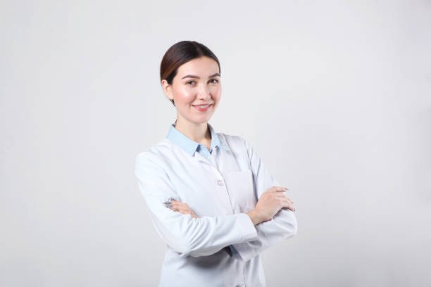 istock Young woman doctor on light background close-up 1355481651