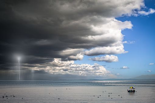 Approaching Storm Front over a Lake with a Boat