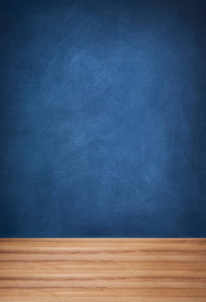 istock Blue Chalkboard and Wooden Floor 1355485680