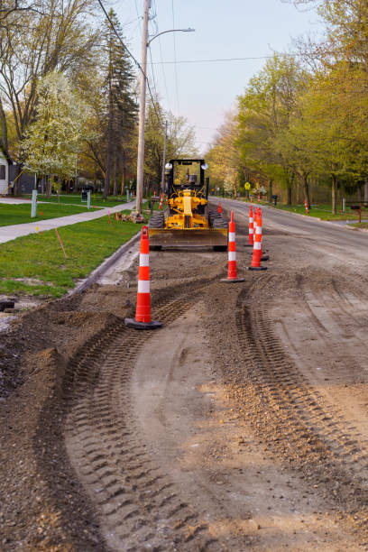 istock Safety Cones Around Road Grader 1355487625