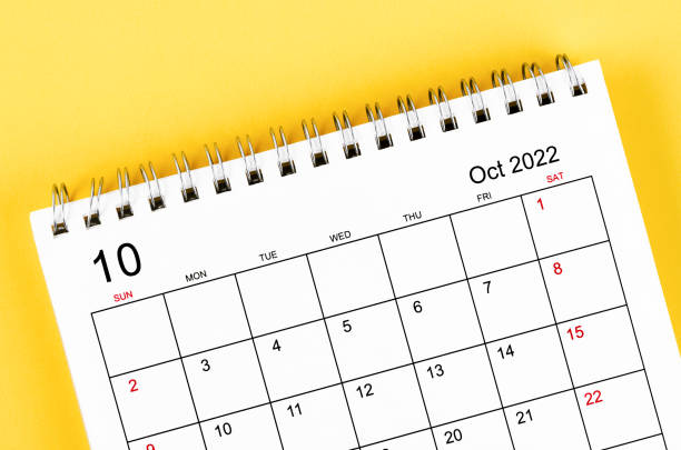 istock October 2022 desk calendar on yellow background. 1355489187