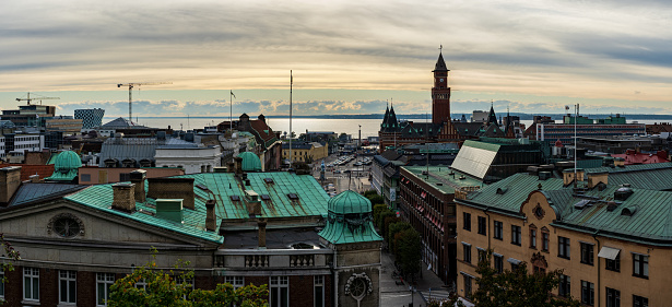 Helsingborg, Sweden - Oct 4, 2020: Cityscape of Helsingborg with town hall and Denmark in the background during sunset.