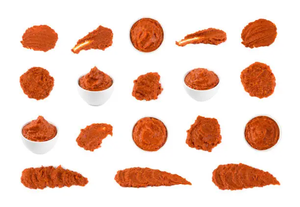 Smear of ajvar or pindjur orange vegetable spread made from bell peppers, eggplants and oil. Marinara sauce smear, salsa, chutney or lutenica set isolated