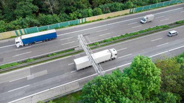 istock Truck toll system on highway - control gantry, aerial view 1355490980