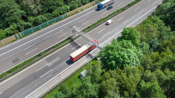 istock Truck toll system on highway - control gantry, aerial view 1355490992
