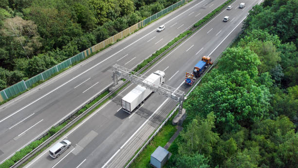 istock Truck toll system on highway - control gantry, aerial view 1355491026