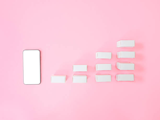 istock Business e-commerce or Marketing strategy concepts from smartphone with blank screen and product box on pink background. Top view 1355491840
