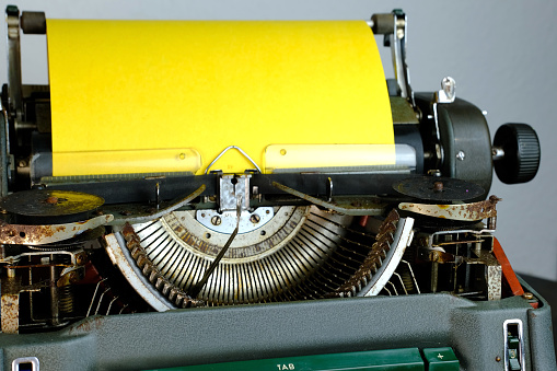 typewriter on table, words fake news are printed on paper in large size, vintage lantern shines, retro style, concept of information hoax in social media, misleading, exposing deception, old school