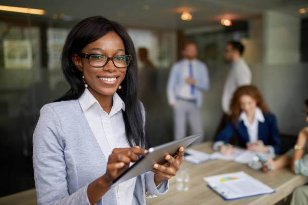 istock Young businesswoman in the office analyzing business report using digital tablet 1355496580