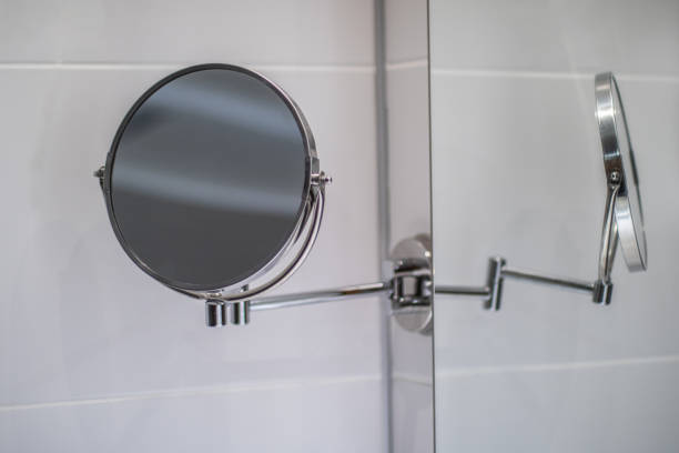 istock makeup mirror hanging over mirrored white wall in hotel bathroom 1355496721