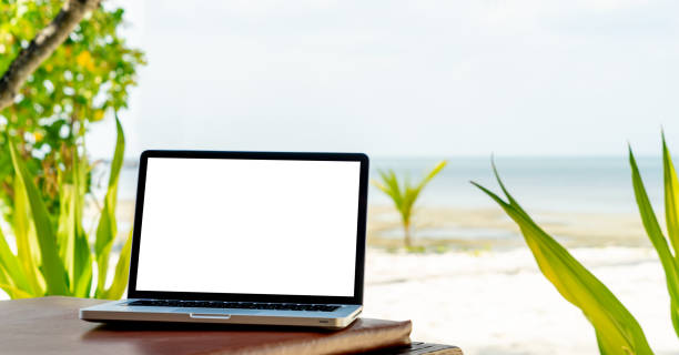 istock Laptop with blank screen on beach chair 1355496772