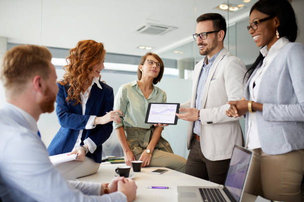 istock Business people discussing new market and sales analysis using digital tablet 1355496864