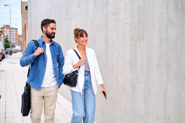 istock Two co-workers walking home after a day's work walking down the sidewalk 1355498259
