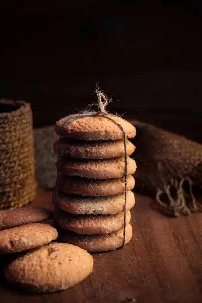 Photo of cookies piled and tied on a wooden theme food photography shot
