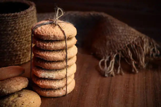 Photo of cookies piled and tied on a wooden theme food photography shot