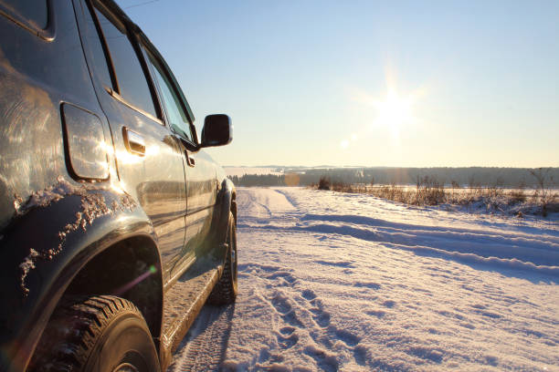 istock A car standing on the roadside near a snowfield. 1355499665