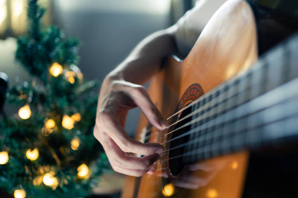 istock Playing classical guitar in Christmas day 1355499790