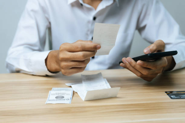 istock business man entering password code on mobile phone paying bill with credit card bill on desk in home office, internet, digital marketing, mobile banking, online payment and digital technology concept 1355500743
