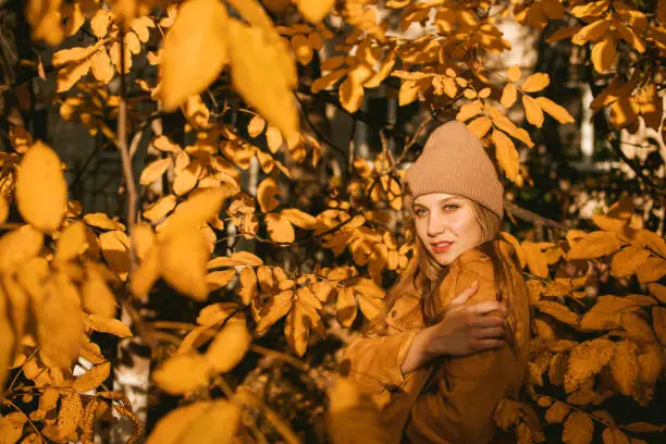 Feel-good Self-care Ideas For Fall, Autumn Self-Care Activities, celebrate the fall season. Young beautiful woman enjoying autumn nature and sun