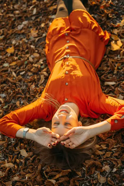 Feel-good Self-care Ideas For Fall, Autumn Self-Care Activities, celebrate the fall season. Young beautiful woman enjoying autumn nature and sun