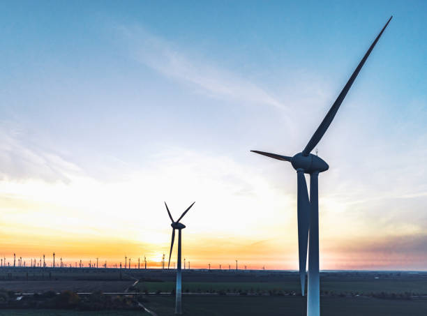 istock wind turbines in sunset landscape 1355501976