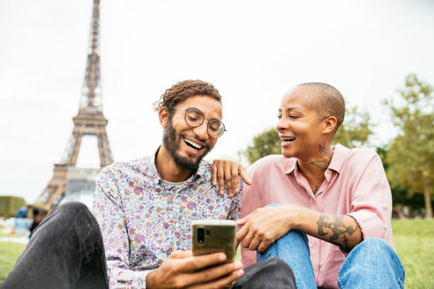 istock Tourists using smart phone near famous landmark 1355502291