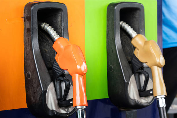 istock Row of refuel nozzle head at gasoline station. 1355502347