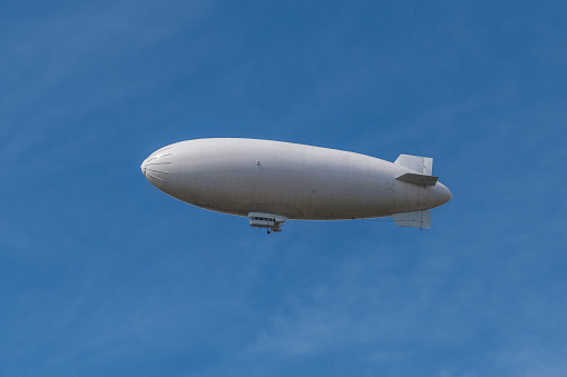 Big white zeppelin in a pale blue sky