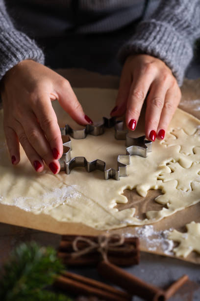 istock Christmas cooking and baking, female hands making cookies from dough 1355505639