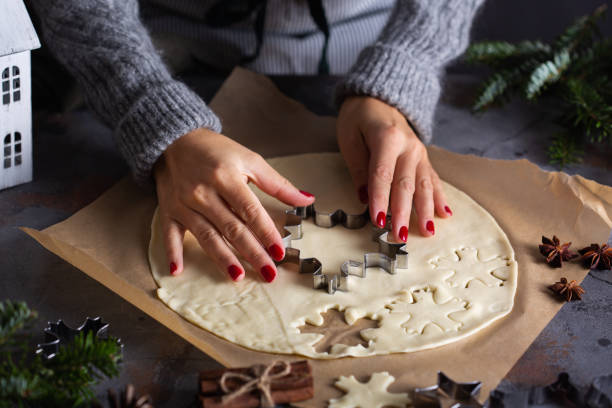 istock Christmas cooking and baking, female hands making cookies from dough 1355505774