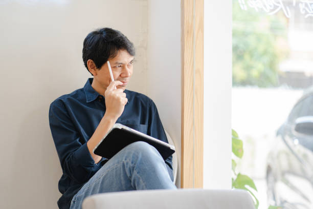istock asian freelancer man during creative and draw digital graphic by use tablet with happiness feeling 1355507198