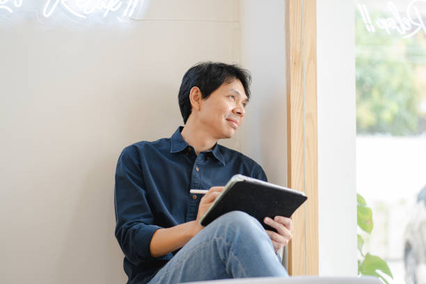 istock asian freelancer man during creative and draw digital graphic by use tablet with happiness feeling 1355507207