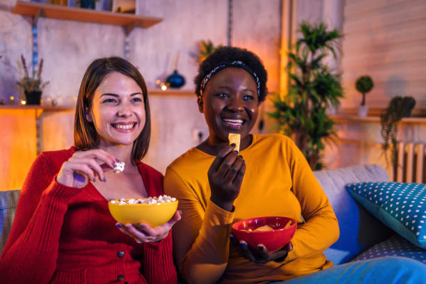 istock Female friends relaxing together at home 1355507253