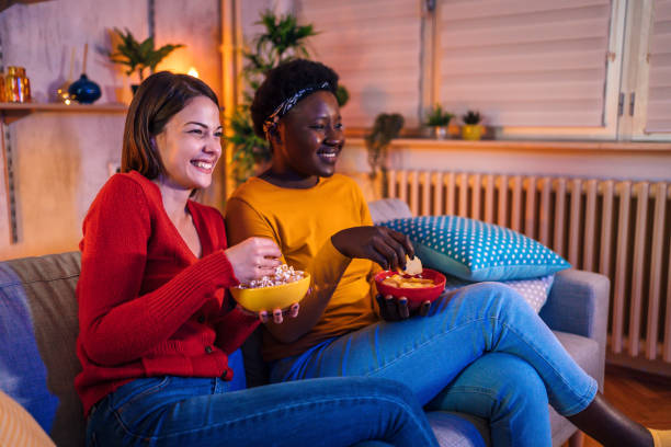 istock Two women watching TV at home 1355507392