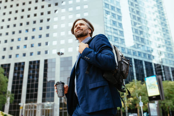 istock Mature businessman in full suit using smart phone in financial district during lockdown 1355507967