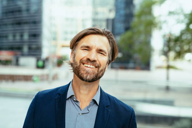 istock Mature businessman in full suit looking at camera 1355507998