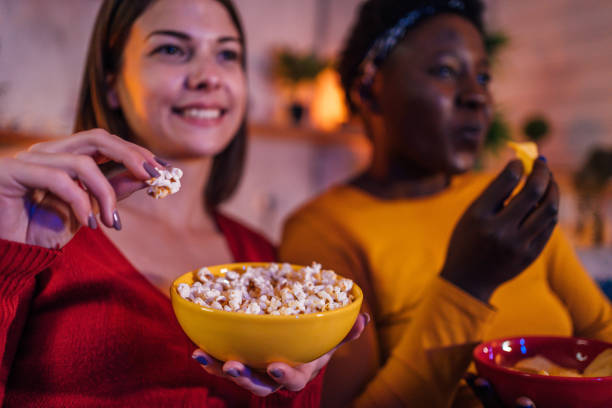 istock Two women watching TV at home 1355508001