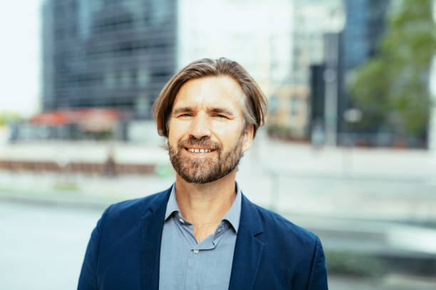 istock Mature businessman in full suit looking at camera 1355508035
