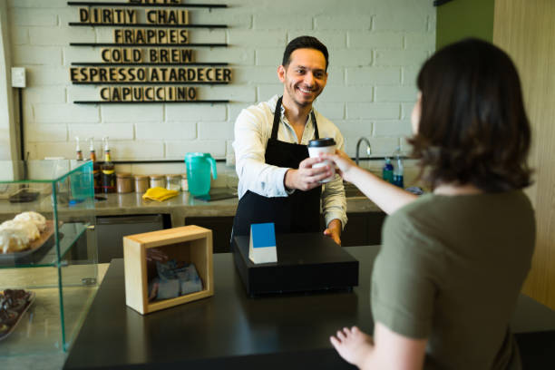 istock Barista serving a female customer 1355508518