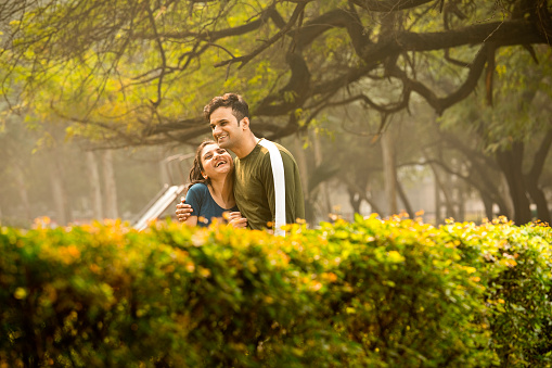Young happy couple in love outdoors. loving man and woman on a walk in a spring blooming park