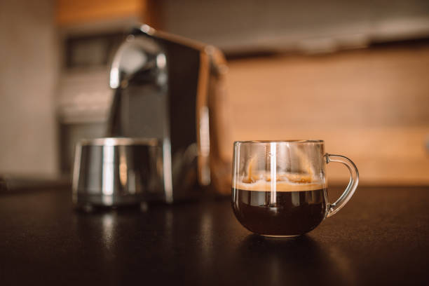 istock Modern professional espresso coffee machine, cup on kitchen table. Having breakfast in the morning 1355510083