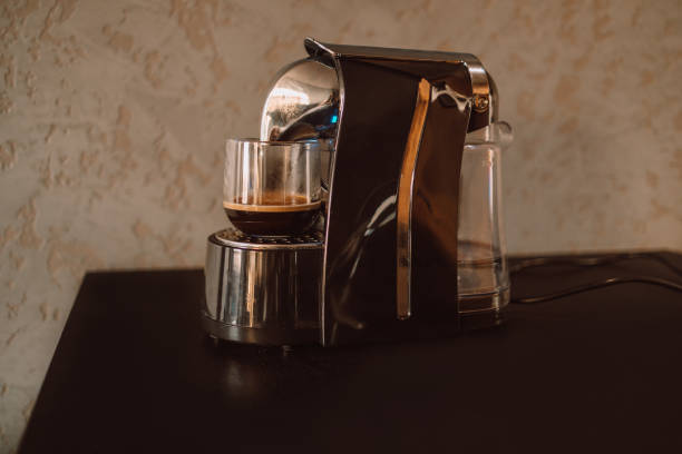 istock Modern professional espresso coffee machine, cup on kitchen table. Having breakfast in the morning 1355510134