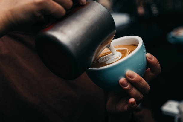 barista pouring latte art photography - coffee latté milk cappuccino fotografías e imágenes de stock