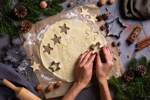 istock Christmas cooking and baking, female hands making cookies from dough 1355511708