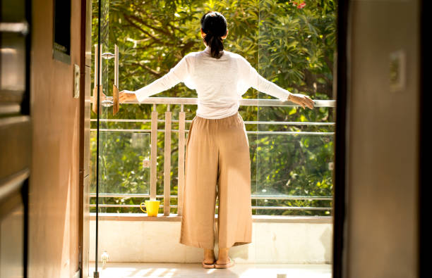 istock Woman admiring view from balcony 1355511723