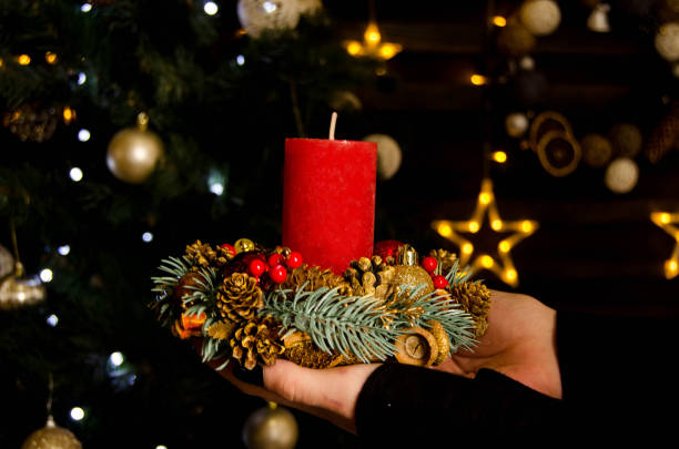 istock red candle stands in hands christmas new year 1355513480
