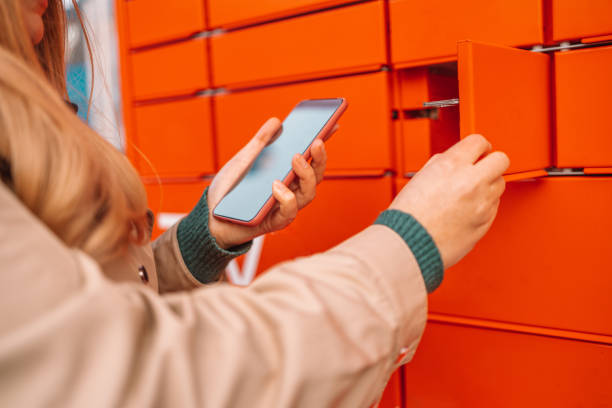 istock Woman client using automated self service post terminal machine or locker,quality delivery service 1355514983