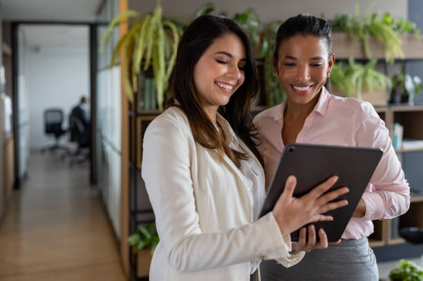 istock Team of business women working at the office and using a tablet computer 1355515319